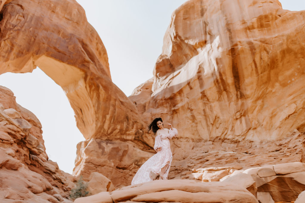 Girl looking down at her dress at the Arches National Park 