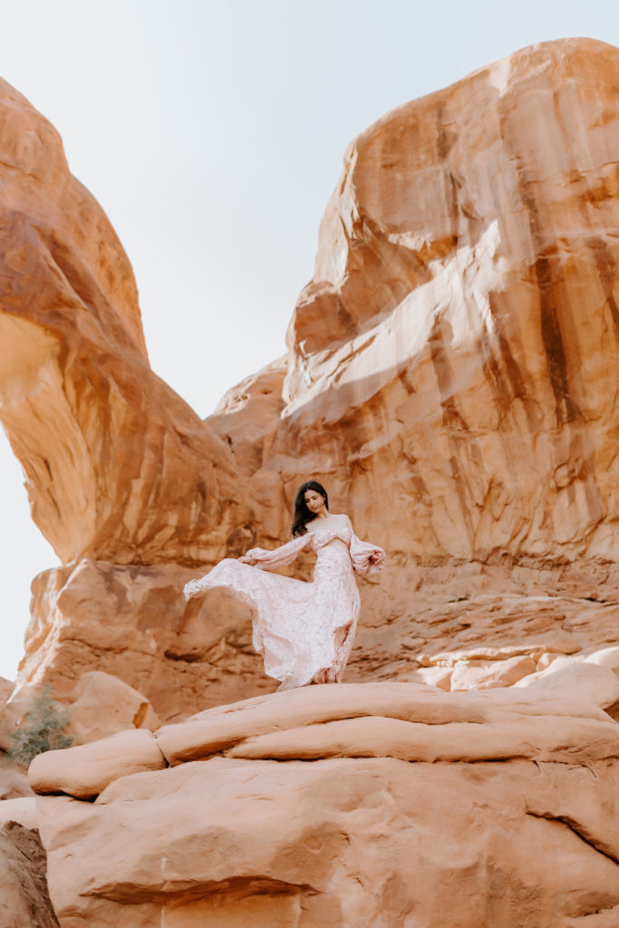 Girl modeling in the dress at her dress at the Arches National Park 
