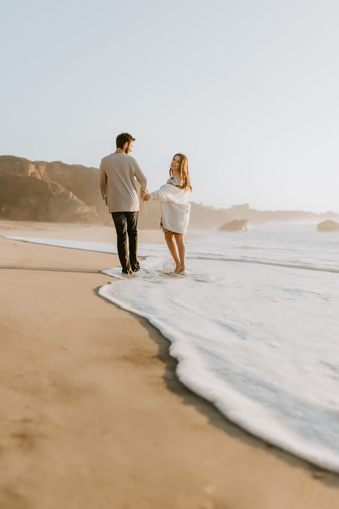 couple walking at the California beach in Big Sur