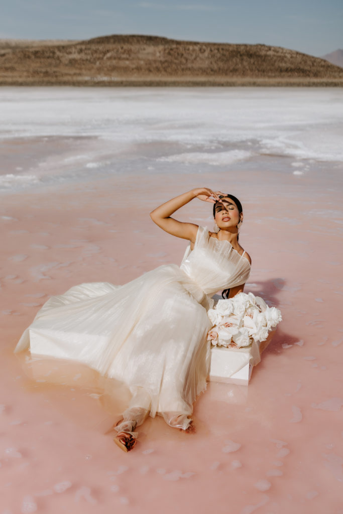 Bride sitting in the pink Lake in Utah