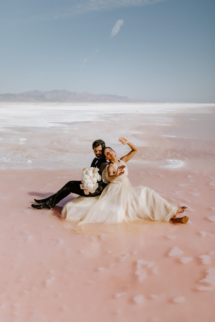 Indian couple sitting in the Pink lake modeling