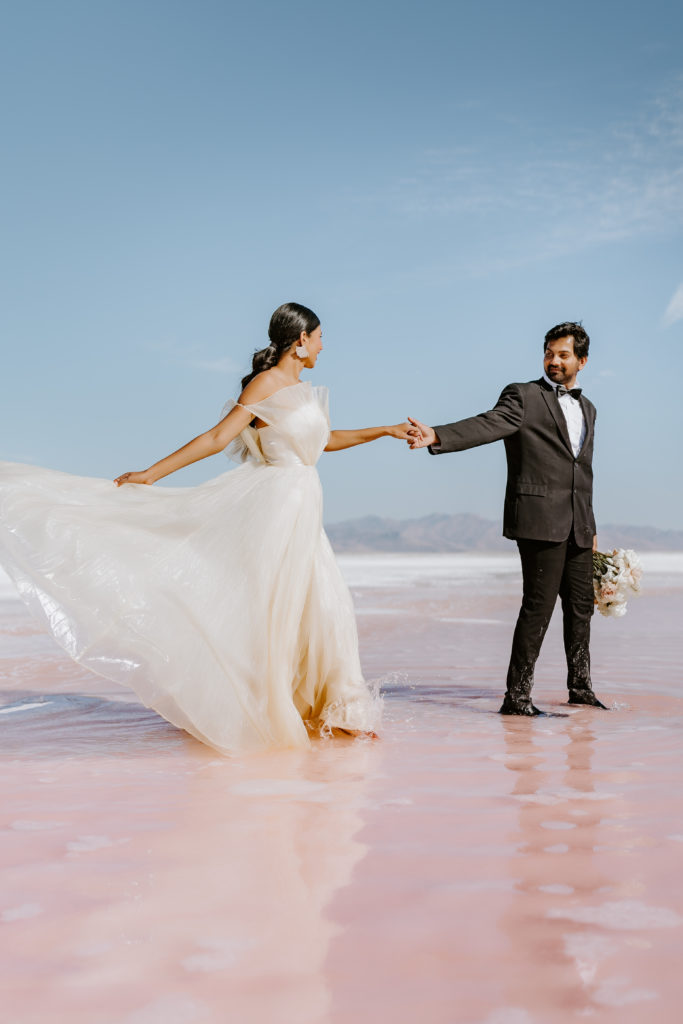 Indian couple walking together in the pink lake Utah