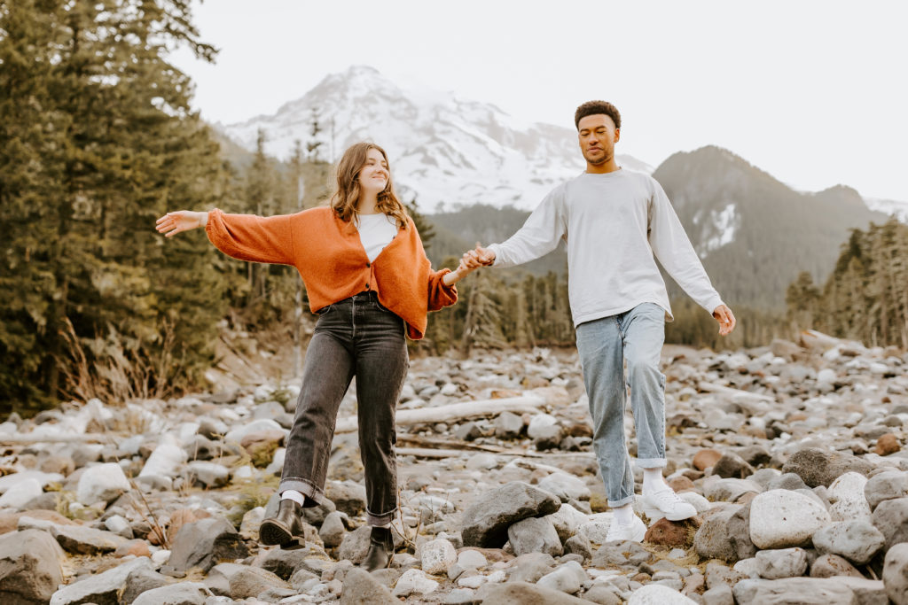 couple holding hands at the Mt. Rainier park