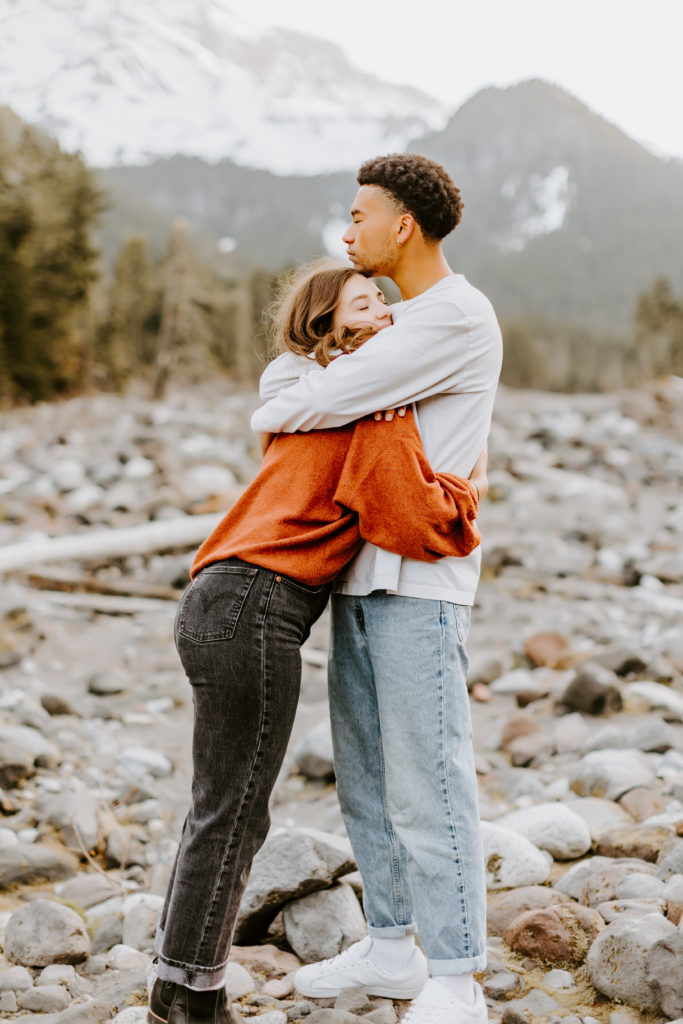 Cute couple hugging at the Mt. Rainier park 
