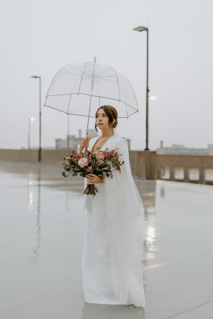 Bride is holding an umbrella on the rooftop at The Hotel Northland, Green Bay
