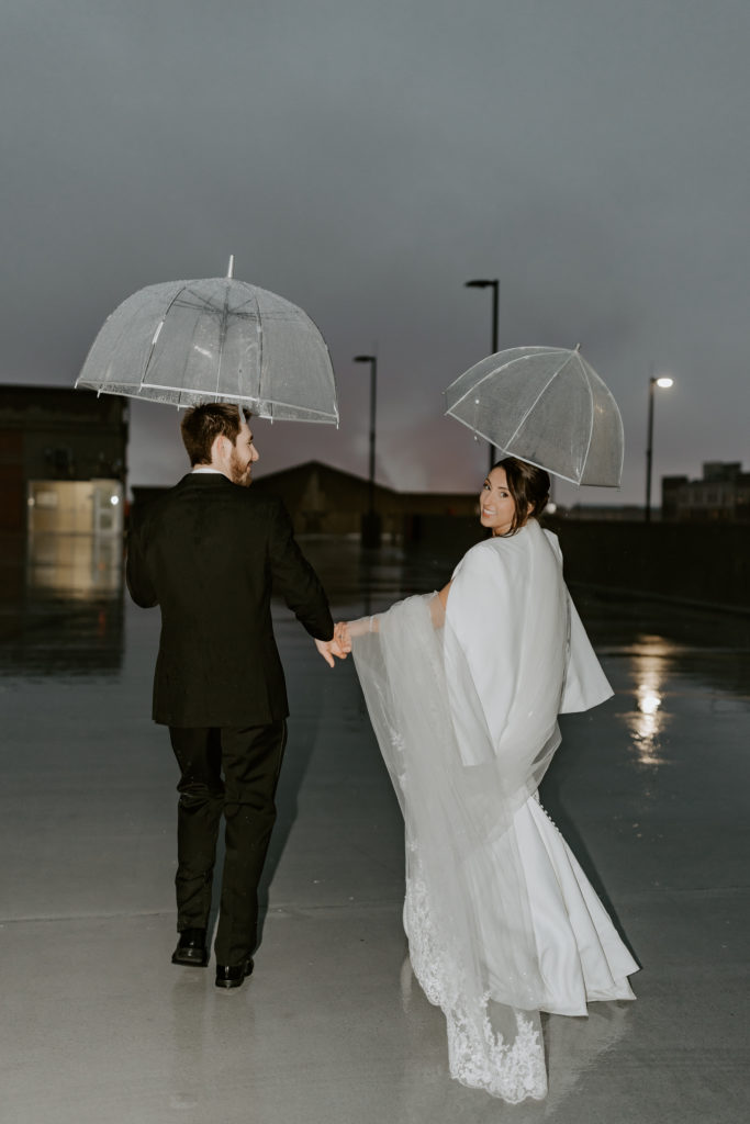 couple walking away holding an umbrellas on the rooftop at The Hotel Northland, Green Bay