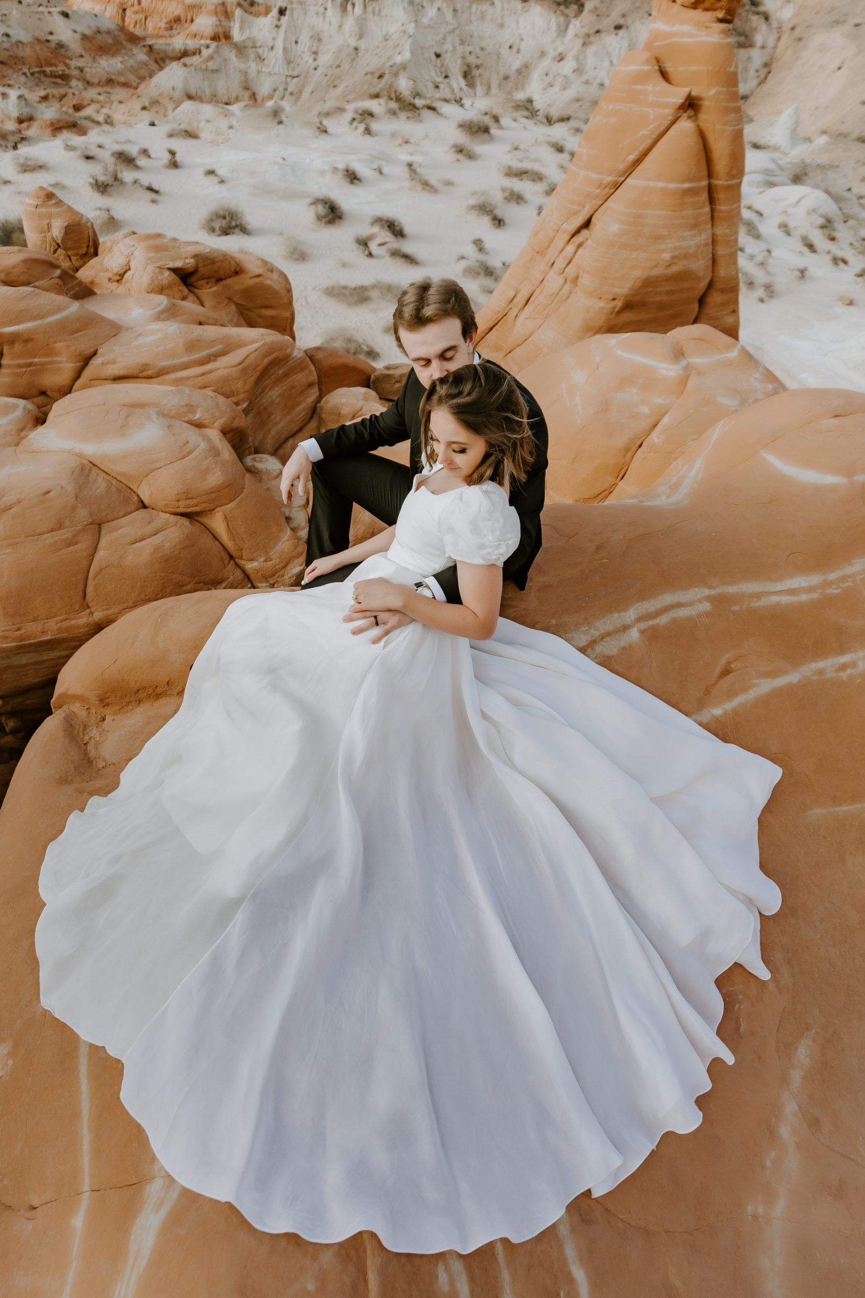  Elopement couple sitting at the Toadstools in Utah